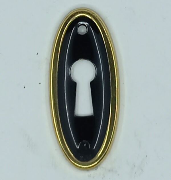 Entrée laiton 20.904.1  or et noir, ovale 44x20mm,  vers 1950.